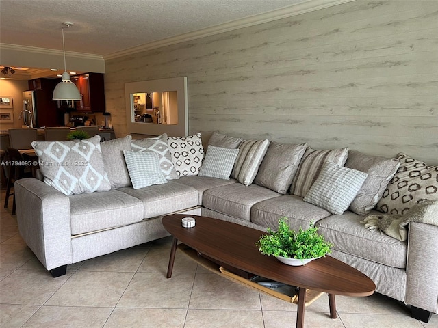 living area with crown molding, a textured ceiling, wooden walls, and light tile patterned flooring