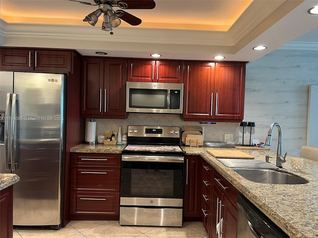 kitchen with crown molding, a ceiling fan, a sink, appliances with stainless steel finishes, and light tile patterned floors