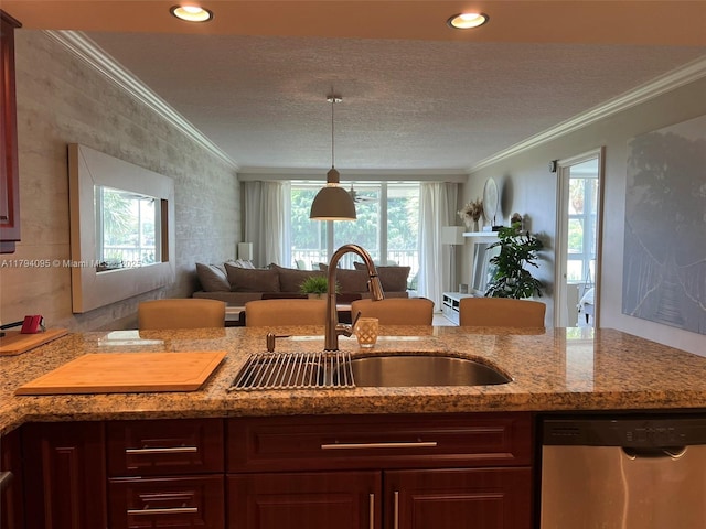 kitchen with a sink, ornamental molding, open floor plan, and dishwasher