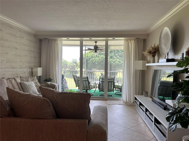 living room with a ceiling fan, a textured ceiling, light tile patterned floors, and a healthy amount of sunlight