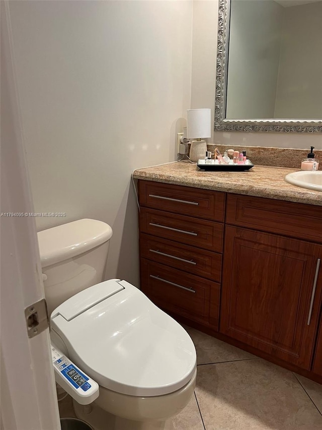 bathroom with tile patterned flooring, toilet, and vanity