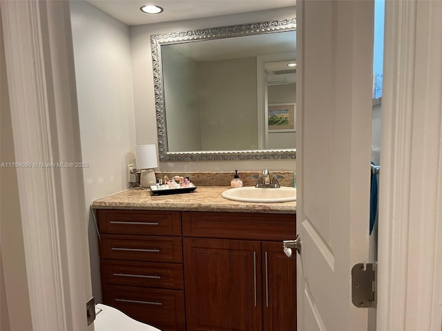 bathroom featuring vanity and recessed lighting