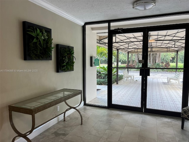 entryway with crown molding, a textured ceiling, and expansive windows