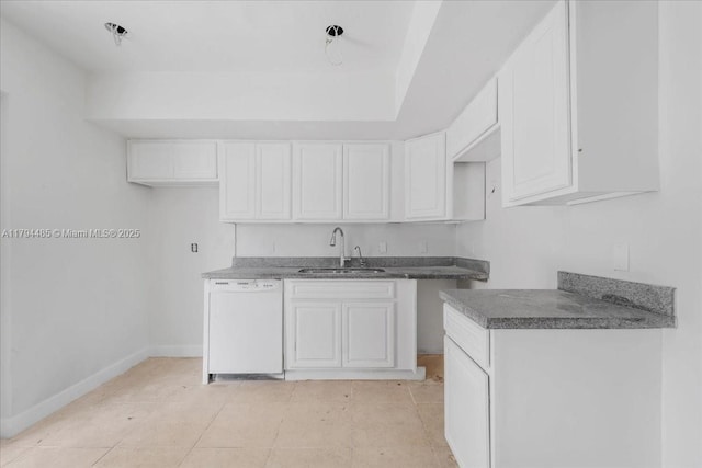 kitchen with white cabinets, baseboards, a sink, and white dishwasher
