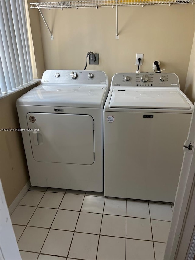 8515 SW 152nd Ave Unit 284, Miami, FL 33193 - laundry room featuring laundry area, washer and clothes dryer, baseboards, and light tile patterned floors