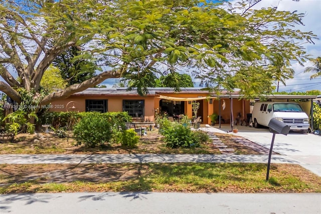 9341 Marine Dr, Cutler Bay, FL 33189 - single story home with stucco siding, an attached carport, and driveway