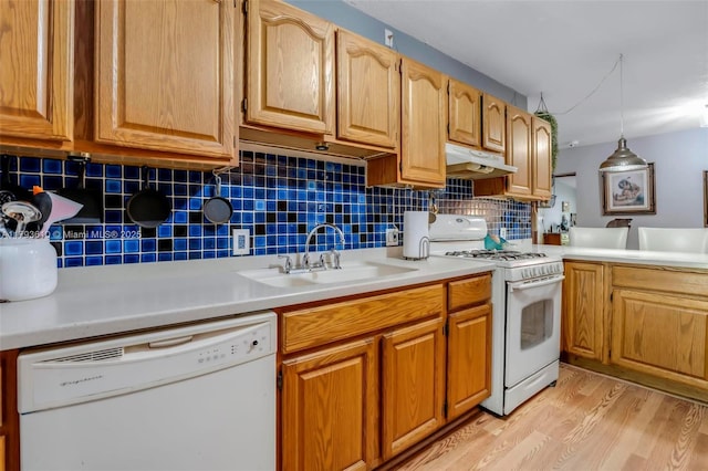 9341 Marine Dr, Cutler Bay, FL 33189 - kitchen with tasteful backsplash, light wood-type flooring, a sink, under cabinet range hood, and white appliances