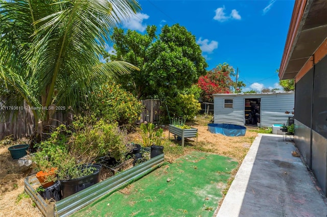 9341 Marine Dr, Cutler Bay, FL 33189 - view of yard featuring a fenced backyard, an outdoor structure, and a vegetable garden