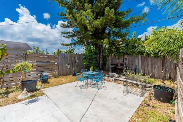 9341 Marine Dr, Cutler Bay, FL 33189 - view of patio featuring outdoor dining area and a fenced backyard