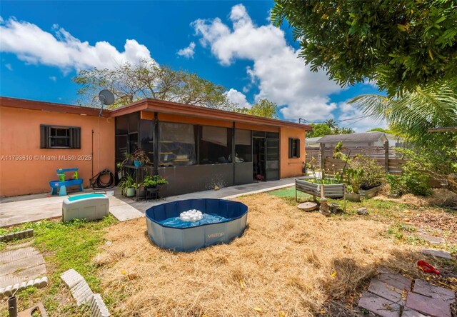 9341 Marine Dr, Cutler Bay, FL 33189 - back of house with a sunroom and a garden