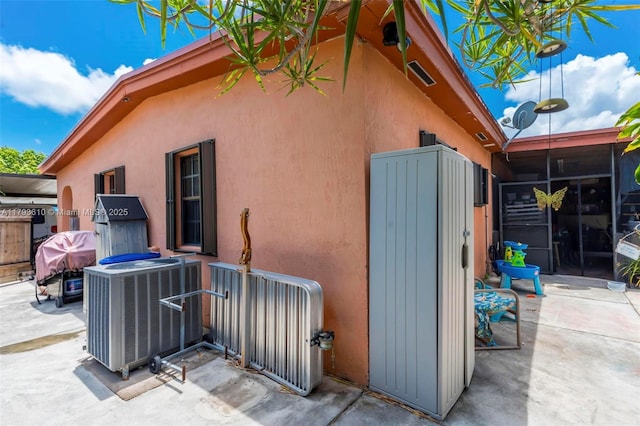 9341 Marine Dr, Cutler Bay, FL 33189 - exterior space featuring a patio, central AC unit, and stucco siding