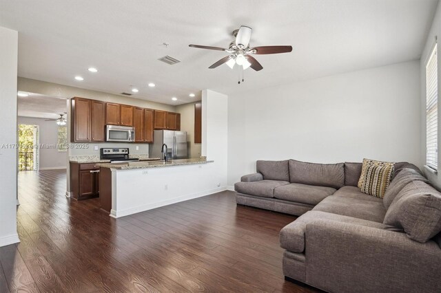 living room with visible vents, recessed lighting, dark wood finished floors, and ceiling fan