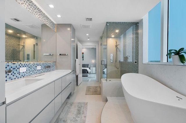 3801 Collins Ave Unit 703, Miami Beach, FL 33140 - full bathroom with double vanity, ensuite bathroom, a shower stall, and a freestanding bath