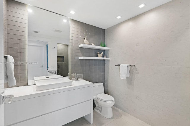 3801 Collins Ave Unit 703, Miami Beach, FL 33140 - bathroom featuring toilet, tile walls, tile patterned flooring, and a stall shower
