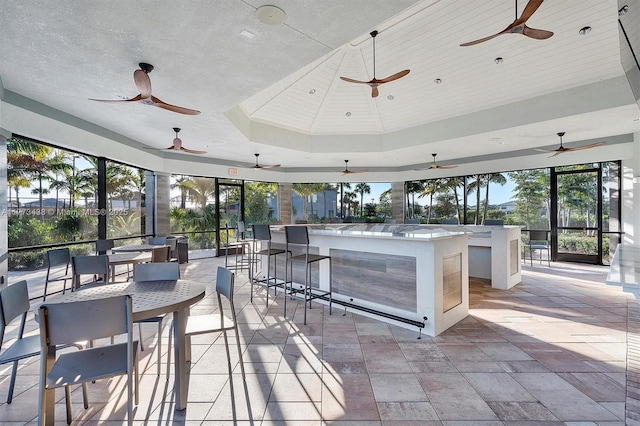 view of patio / terrace featuring outdoor dry bar and a ceiling fan