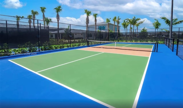 view of tennis court featuring fence and community basketball court