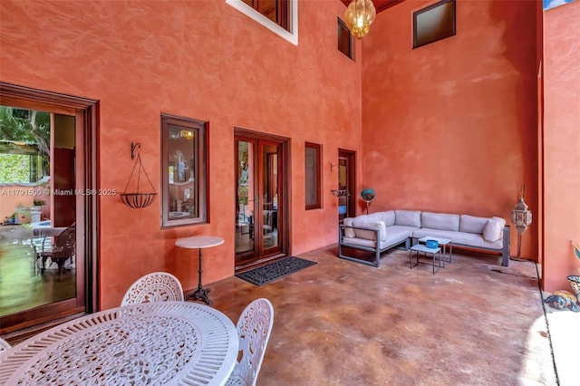 interior space featuring a patio, outdoor lounge area, and french doors