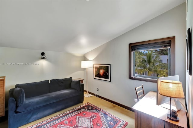living area featuring baseboards, carpet, and vaulted ceiling