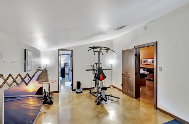 exercise area with baseboards, visible vents, and vaulted ceiling