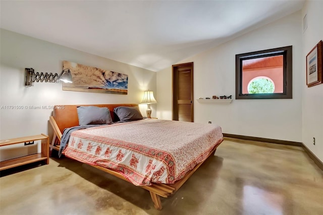 bedroom with baseboards, carpet flooring, and lofted ceiling