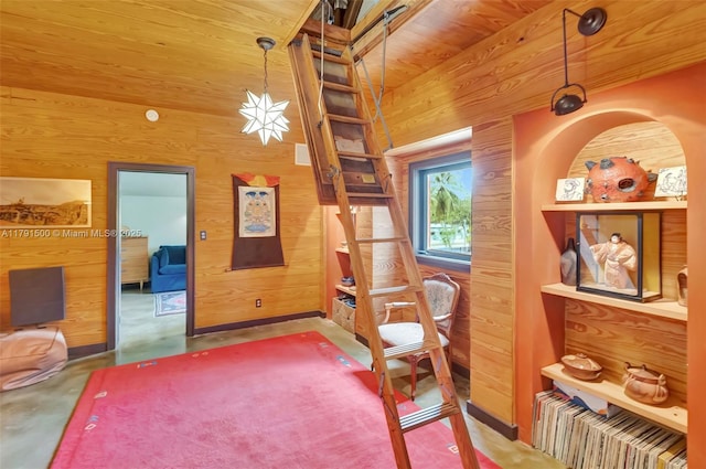 sitting room with wood walls and concrete floors