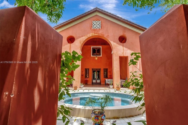 view of pool with french doors and a pool