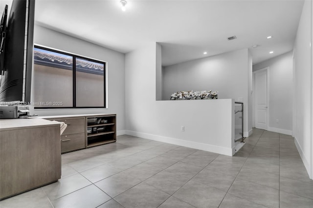 interior space featuring visible vents, light tile patterned floors, baseboards, light countertops, and recessed lighting