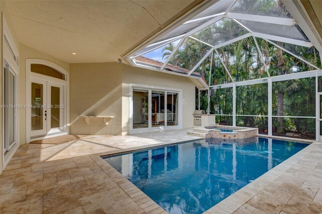4 Mccairn Ct, Palm Beach Gardens, FL 33418 - view of swimming pool featuring a lanai, a patio area, and a pool with connected hot tub