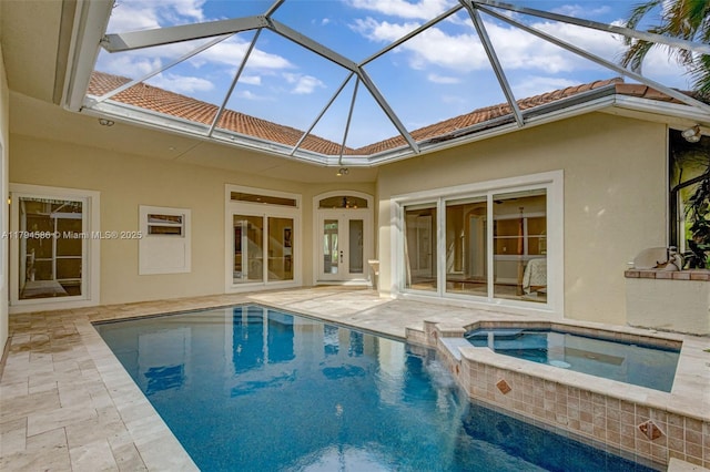 4 Mccairn Ct, Palm Beach Gardens, FL 33418 - view of swimming pool featuring a patio, a pool with connected hot tub, and glass enclosure