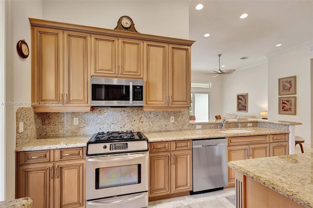 4 Mccairn Ct, Palm Beach Gardens, FL 33418 - kitchen with backsplash, light stone countertops, appliances with stainless steel finishes, and a sink