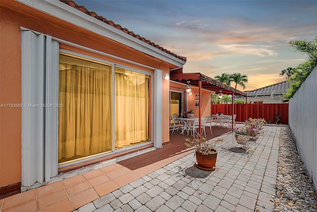 13230 NW 10th St, Miami, FL 33182 - patio terrace at dusk featuring a fenced backyard and outdoor dining space