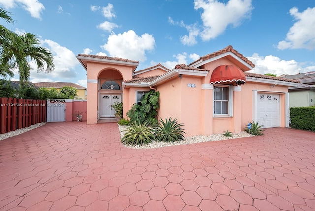 13230 NW 10th St, Miami, FL 33182 - mediterranean / spanish home with fence, an attached garage, stucco siding, a gate, and decorative driveway