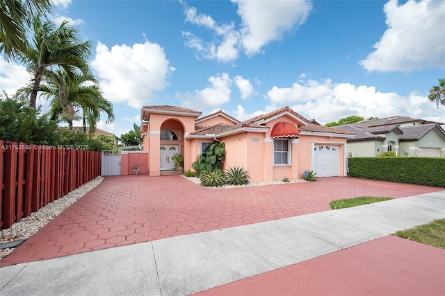 13230 NW 10th St, Miami, FL 33182 - mediterranean / spanish-style house with a garage, stucco siding, a gate, decorative driveway, and a tiled roof