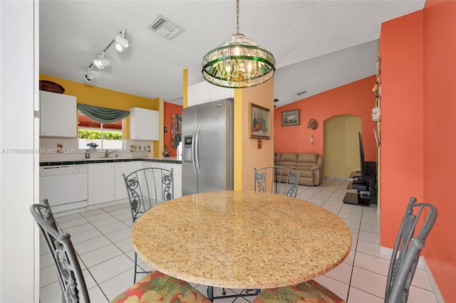 13230 NW 10th St, Miami, FL 33182 - dining room with arched walkways, a textured ceiling, light tile patterned flooring, and visible vents
