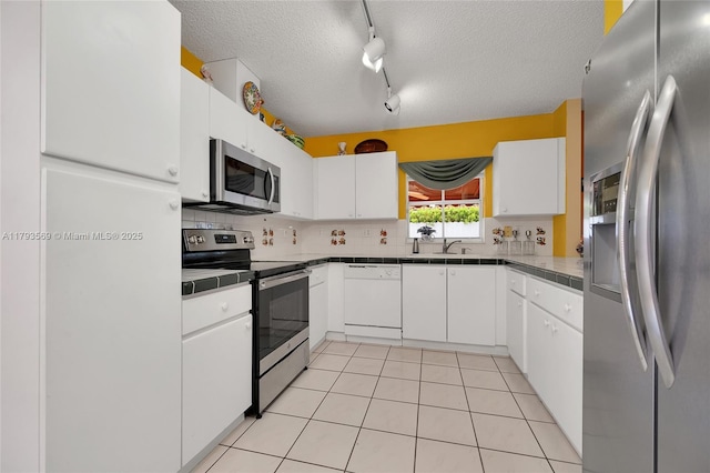 13230 NW 10th St, Miami, FL 33182 - kitchen with white cabinets, stainless steel appliances, rail lighting, and a textured ceiling