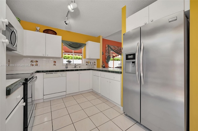 13230 NW 10th St, Miami, FL 33182 - kitchen featuring a textured ceiling, white cabinets, and stainless steel appliances