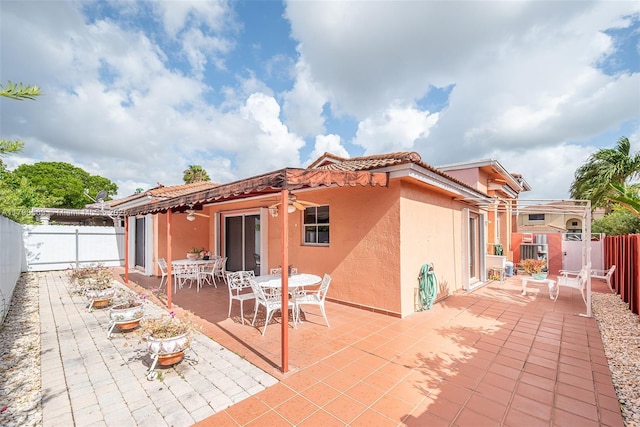 13230 NW 10th St, Miami, FL 33182 - back of house featuring a fenced backyard, a patio, stucco siding, and a tile roof