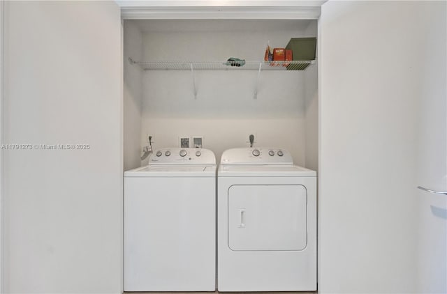 laundry area with separate washer and dryer and laundry area