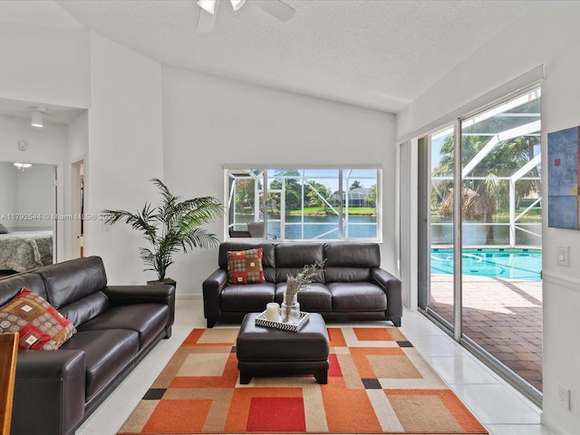 1230 SW 102nd Ave, Pembroke Pines, FL 33025 - living room with ceiling fan, tile patterned flooring, vaulted ceiling, and a textured ceiling