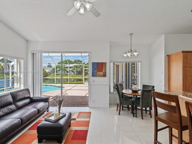 1230 SW 102nd Ave, Pembroke Pines, FL 33025 - living area with a textured ceiling, ceiling fan with notable chandelier, and light tile patterned flooring