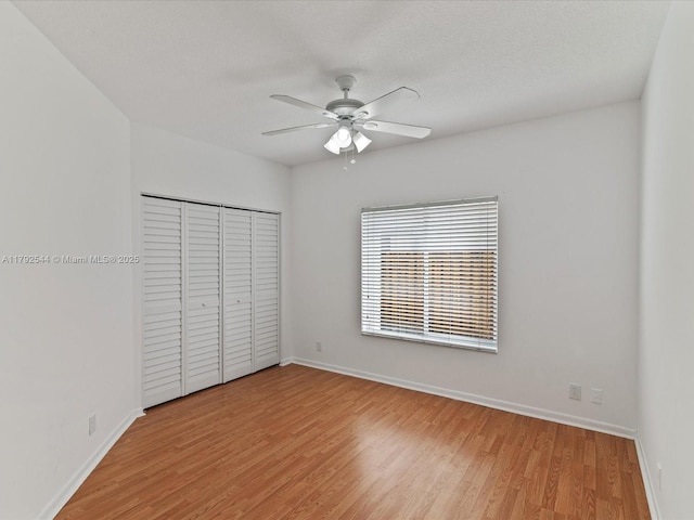 1230 SW 102nd Ave, Pembroke Pines, FL 33025 - unfurnished bedroom with baseboards, ceiling fan, a closet, and light wood-type flooring