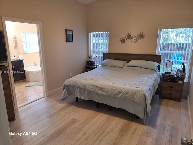 20401 SW 1st St, Pembroke Pines, FL 33029 - bedroom featuring baseboards, light wood-style flooring, and ensuite bathroom