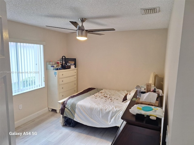 20401 SW 1st St, Pembroke Pines, FL 33029 - bedroom with visible vents, wood finished floors, baseboards, a textured ceiling, and a ceiling fan