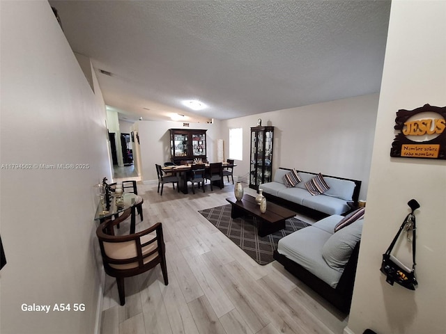 20401 SW 1st St, Pembroke Pines, FL 33029 - living area featuring baseboards, a textured ceiling, and light wood-style flooring