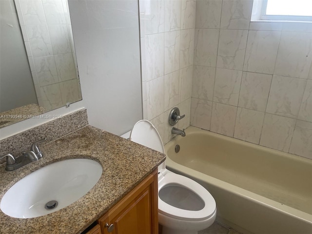 bathroom with vanity, bathtub / shower combination, and toilet