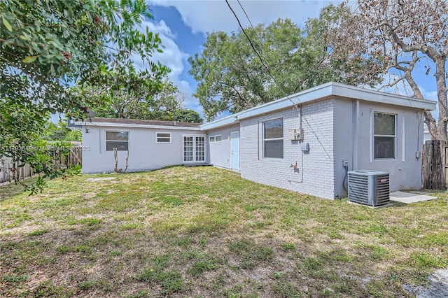 6437 Custer St, Hollywood, FL 33024 - rear view of property featuring a yard, central AC unit, a fenced backyard, and french doors
