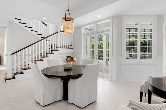 730 Santurce Ave, Coral Gables, FL 33143 - dining space featuring crown molding, wainscoting, a decorative wall, stairway, and light tile patterned floors