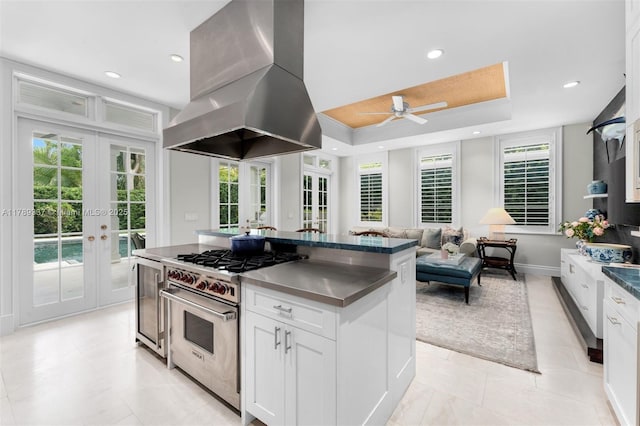 730 Santurce Ave, Coral Gables, FL 33143 - kitchen with white cabinets, ceiling fan, french doors, island range hood, and luxury stove