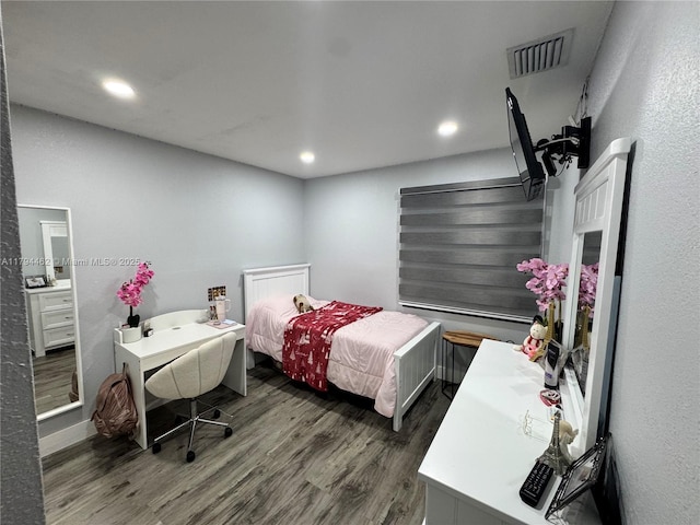 bedroom with recessed lighting, wood finished floors, and visible vents
