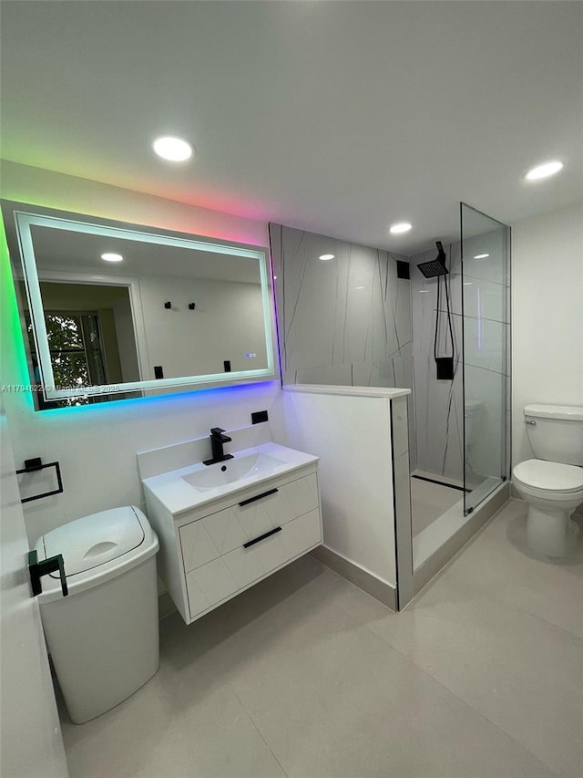 bathroom with recessed lighting, vanity, walk in shower, and toilet